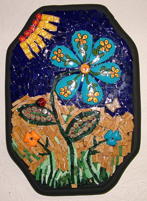 Mosaic flower wall plaque made with smalti glass, millefiori and ceramic tile.