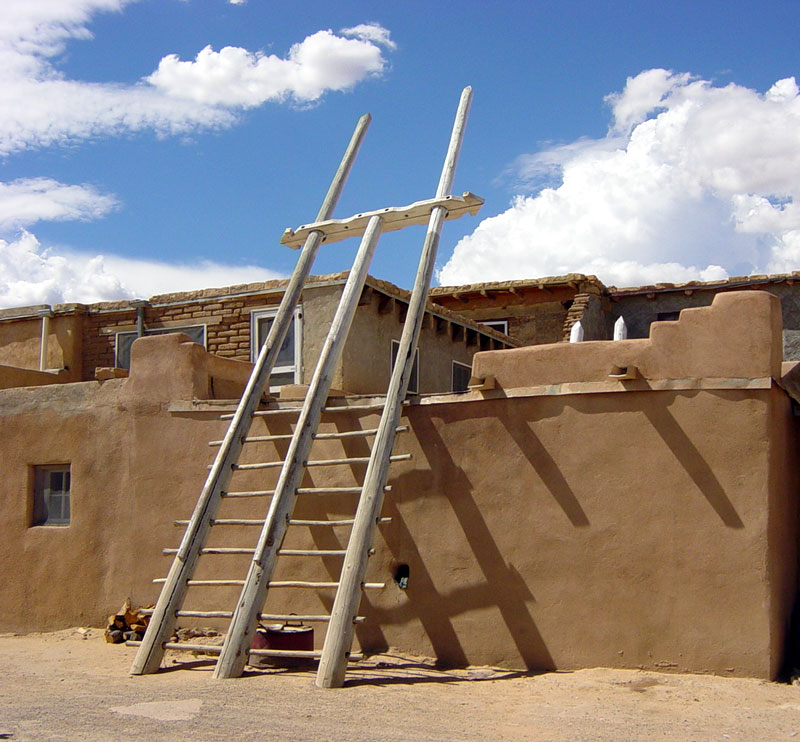 A double ladder to the roof of a house in Acoma