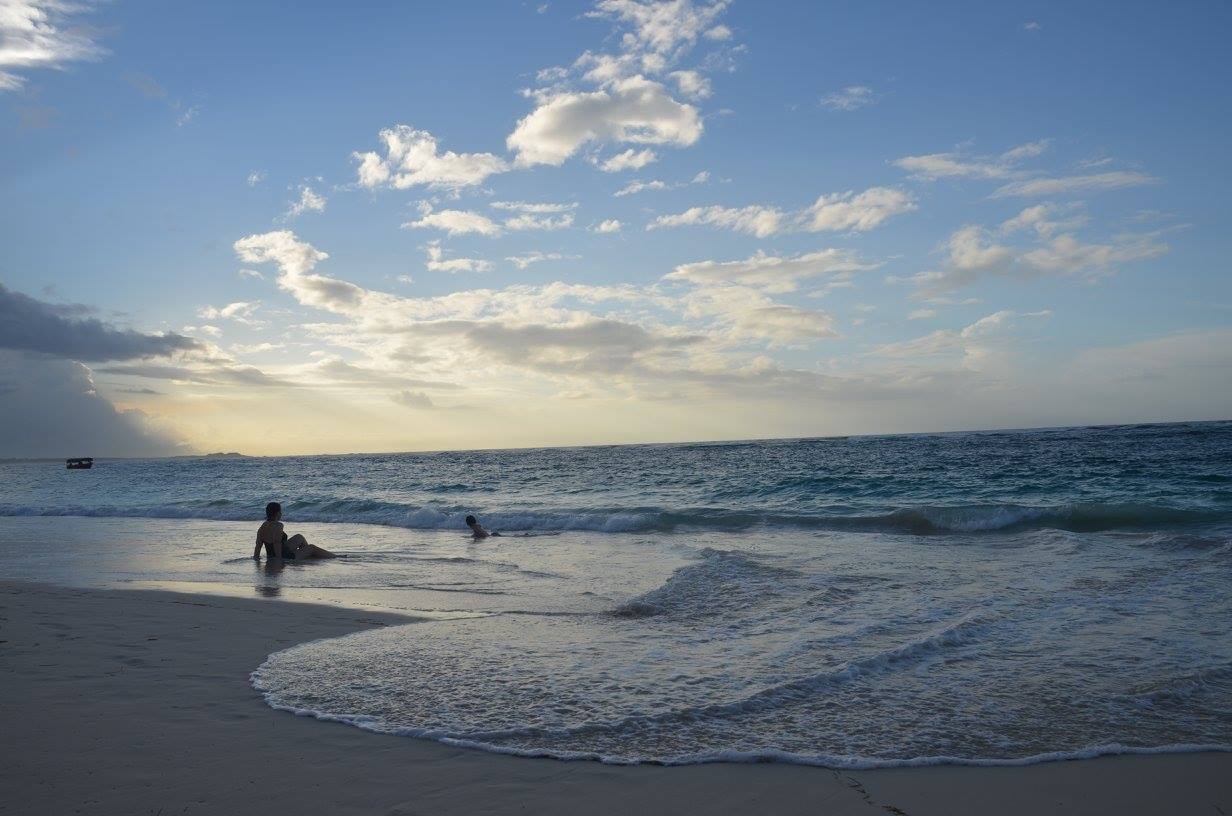 A mother and child enjoy the beach in the late afternoon.