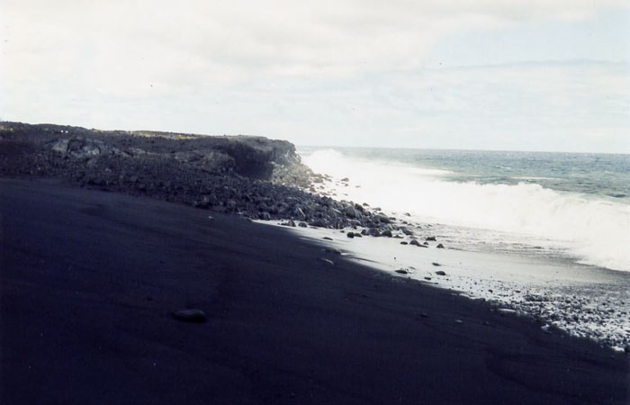 Black sand beach formed by the breakdown of black lava rocks