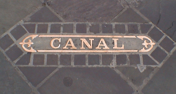 Canal Street sign embedded in the sidewalk