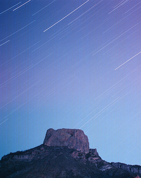 Star trails streak across the sky in this extended exposure of Casa Grande in Big Bend National Park.