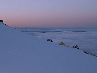 These pictures were taken with a Kodak DC 40 while mountain climbing up Mt. Hood in Oregon. The climb was begun at 1 am during and ice and rain storm. By 3 am they were above the clouds at 8,000 ft. The climbers reached the summit, 11,245 ft., around 9 am and returned to base camp by noon. This was an 11 hr. climb. Notice the camp tents in the background.