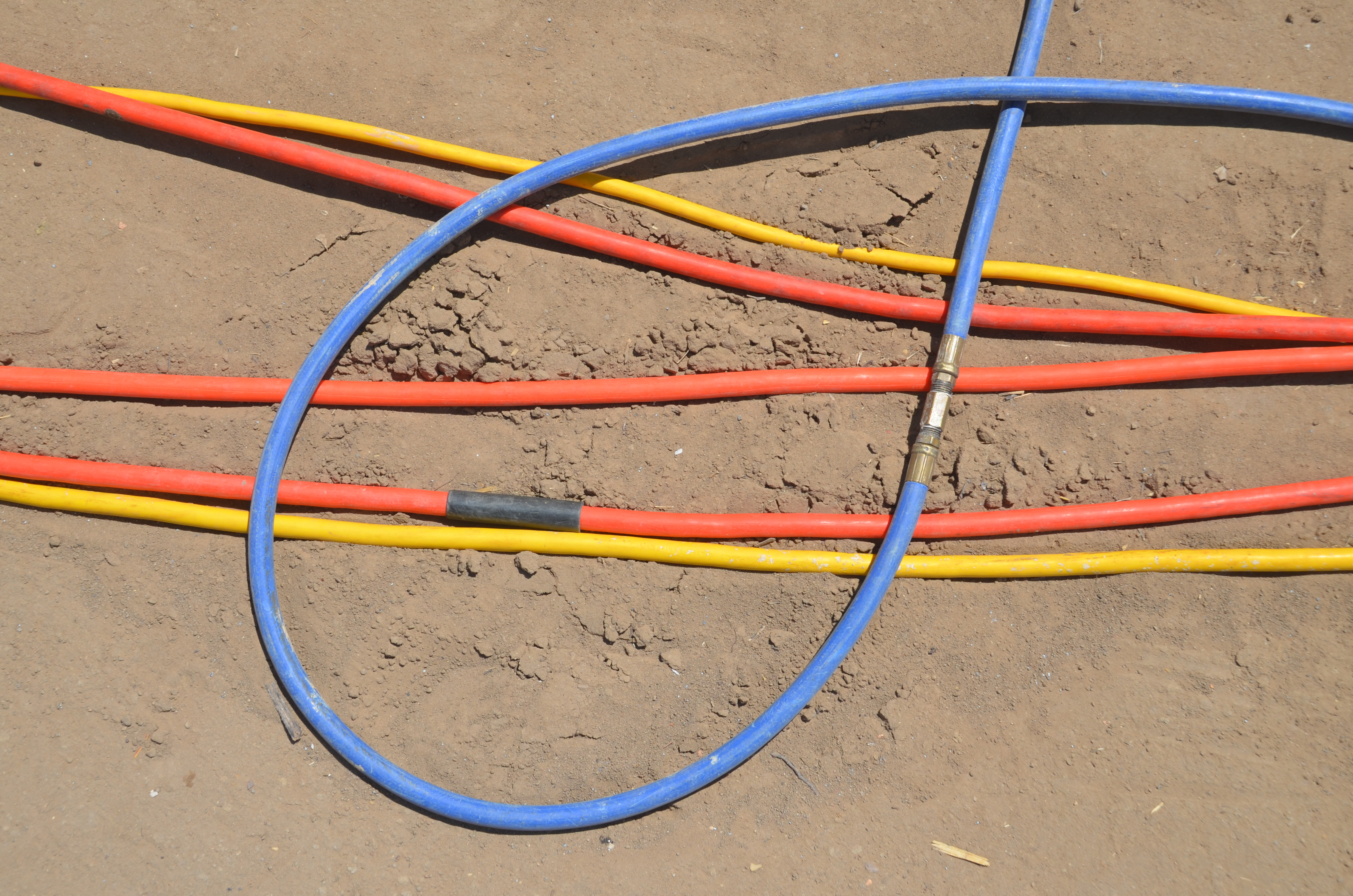 Construction air hoses on sand