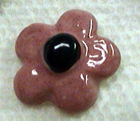 Ceramic flower about a half inch in size