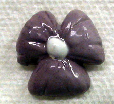 Ceramic flower tile about one inch in size