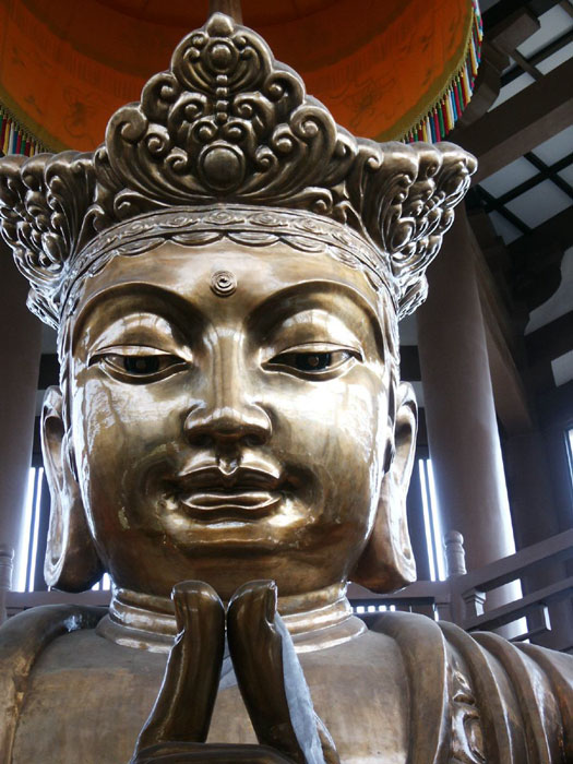 A three-story tall statue of Buddha is in one of the towers.