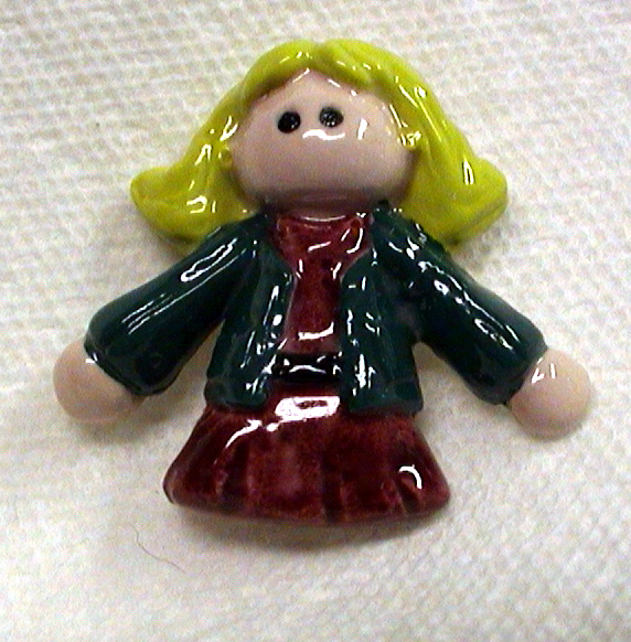 Ceramic girl tile about three inches tall