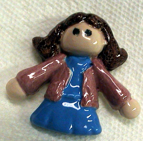 Ceramic tile girl about three inches tall