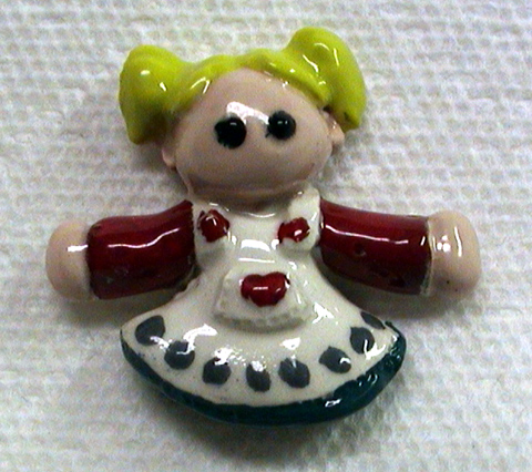 Ceramic girl tile about two and a half inches tall