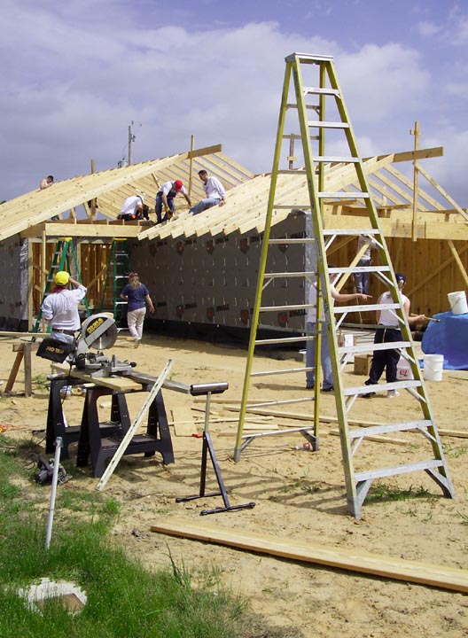 Numerous volunteers are needed to build a house for a Habitat for Humanity project.