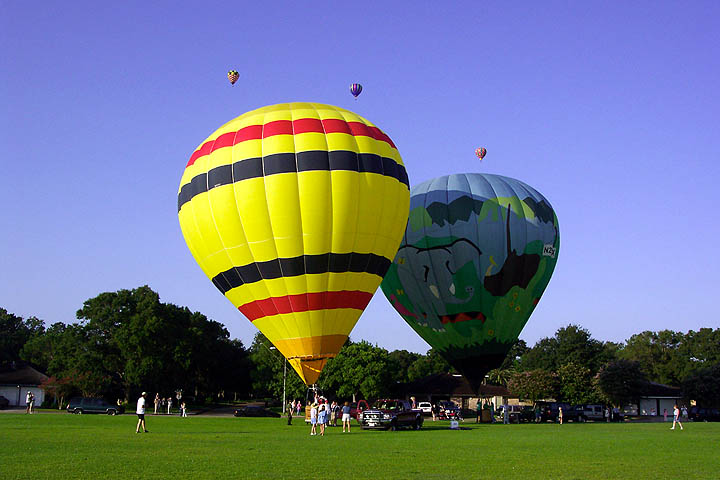 A couple of balloons prepare to join the others.