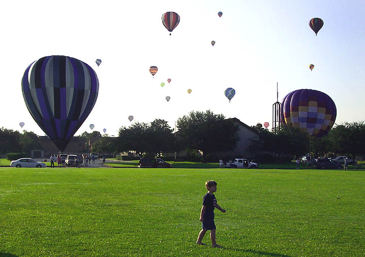 A young boy marvels at all the balloons taking off for the Ballunar Festival.