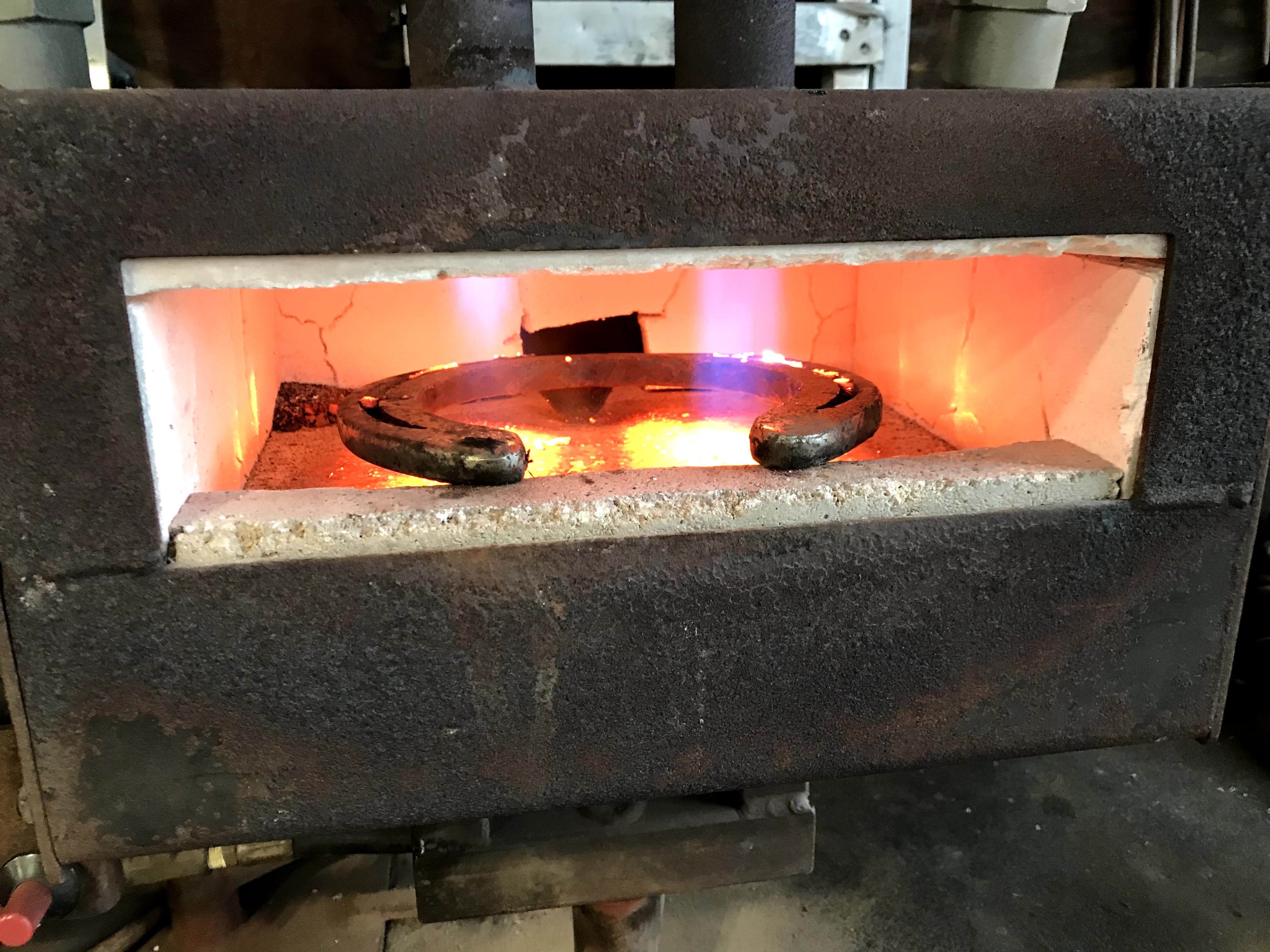 A farrier will heat up a horseshoe in a kiln (furnace) before preparing it to be mounted.