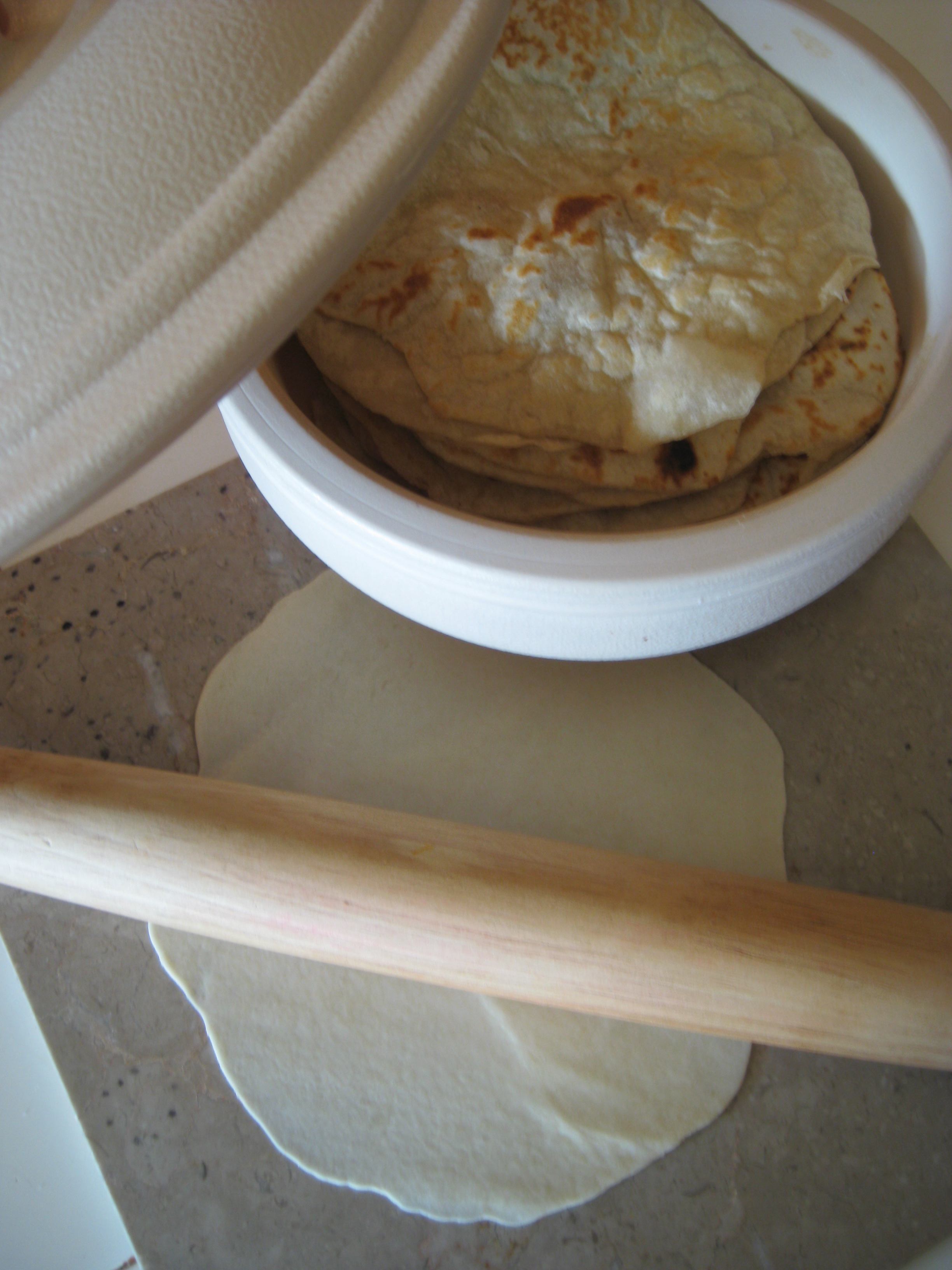 Rolling out the masa for tortillas de Harina