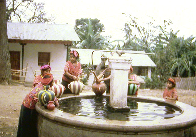 Lake Atitlan Village women gathering water in striped water jugs