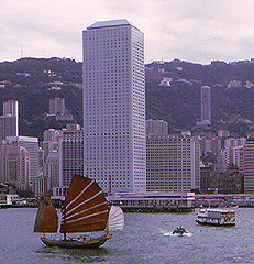 Junk at high sail in Hong Kong harbor