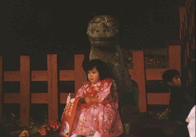 Girl waiting outside temple during