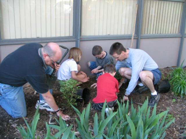 Planting flowers at the Courtyard Campout