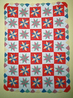 This is a quilt that has a pin wheel baby pattern for the design.