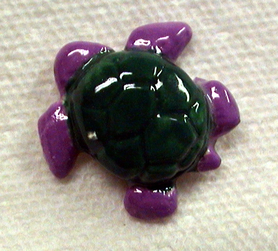 Ceramic turtle tile about one inch in size