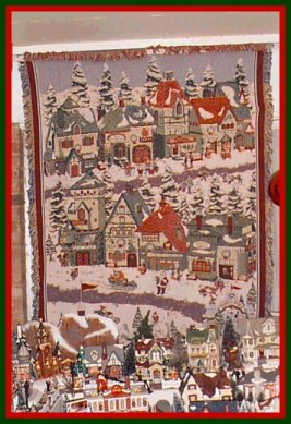 Tapestry of Winter Scene with Ceramic Village Collection in Foreground