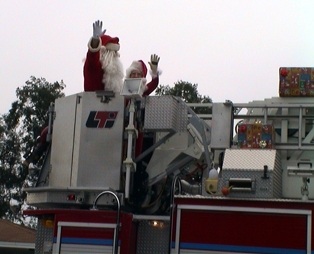 Apopka Christmas Parade 2022 Santa and Mrs. Claus on a fire truck at the end of the Apopka FL parade
