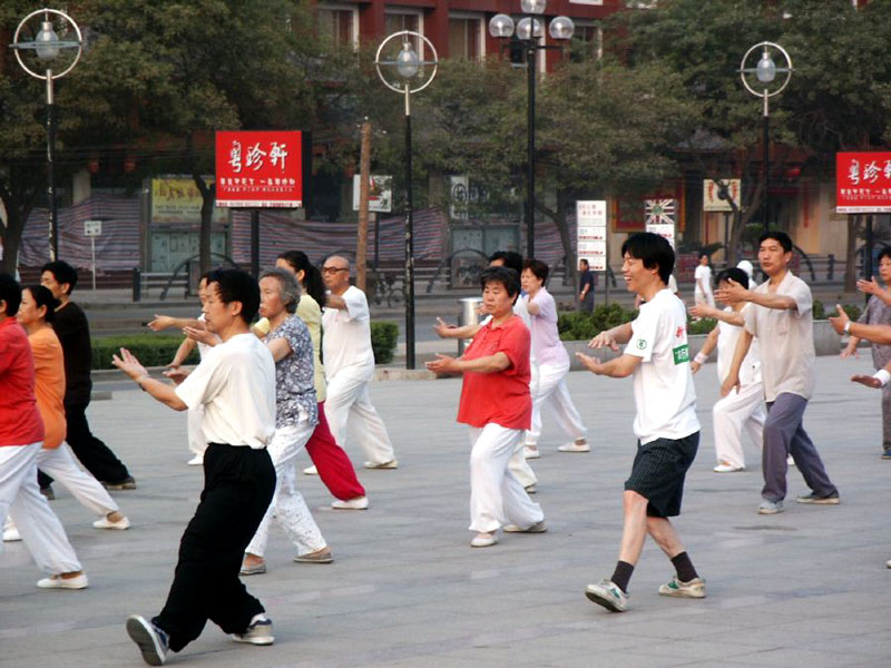 People doing Tai-Chi on the sidewalk in the early morning | Pics4Learning